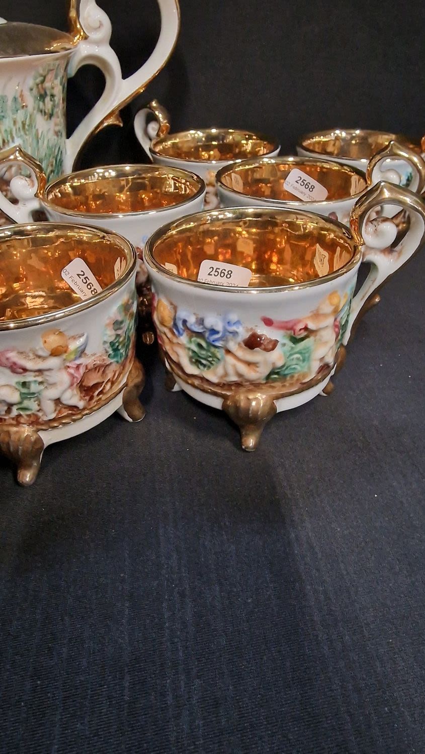 Lot 77: A GV Capodimonte tea service featuring gilt edging...