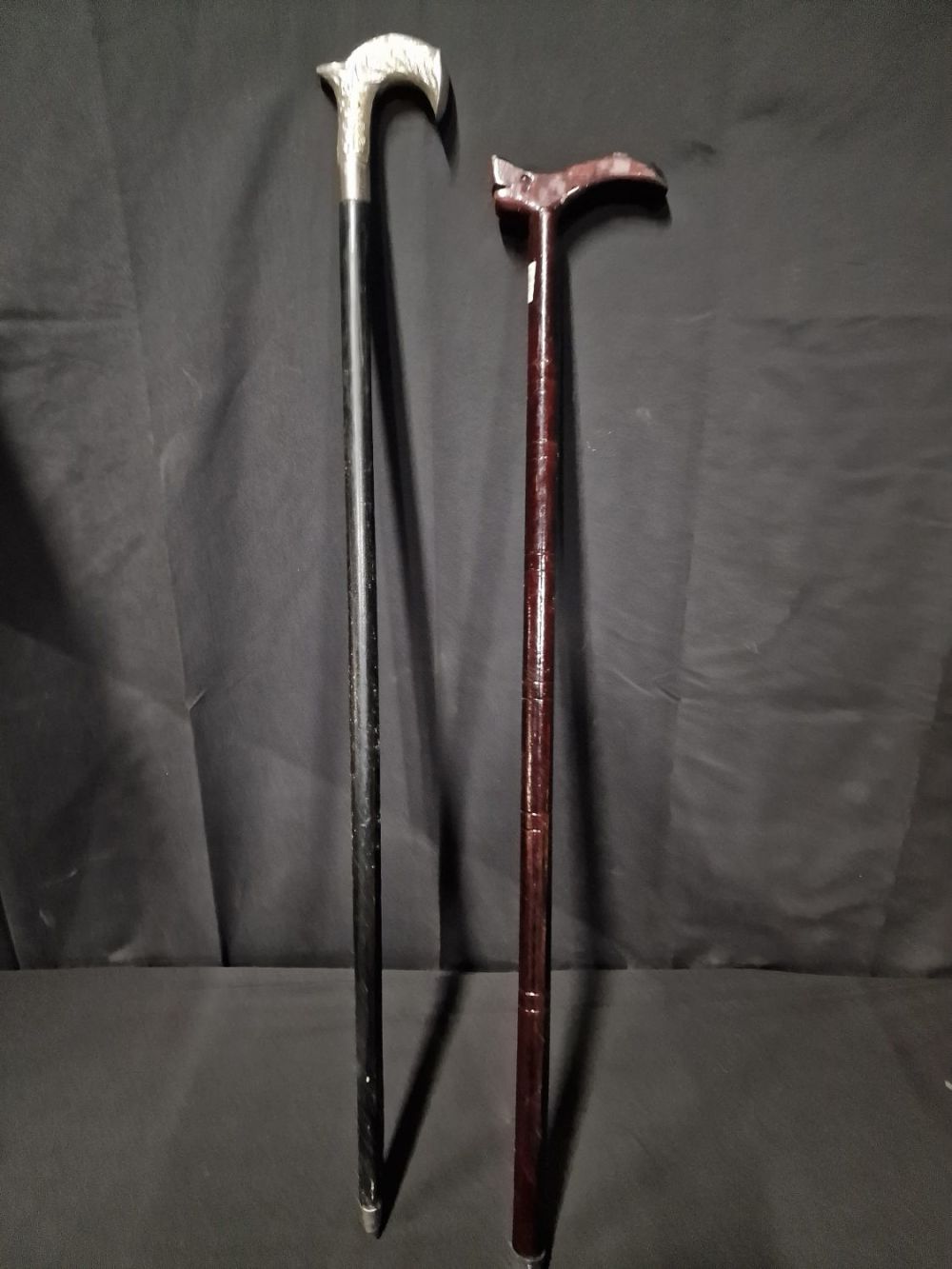 Lot 210: Two vintage walking sticks. One with white metal...