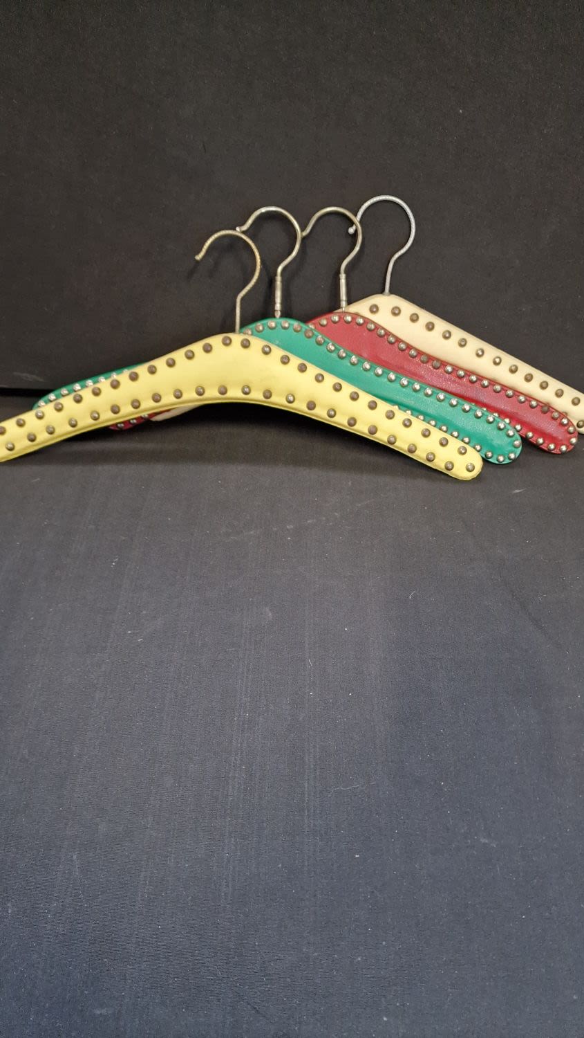 Lot 332: Four vintage faux leather studded coat hangers