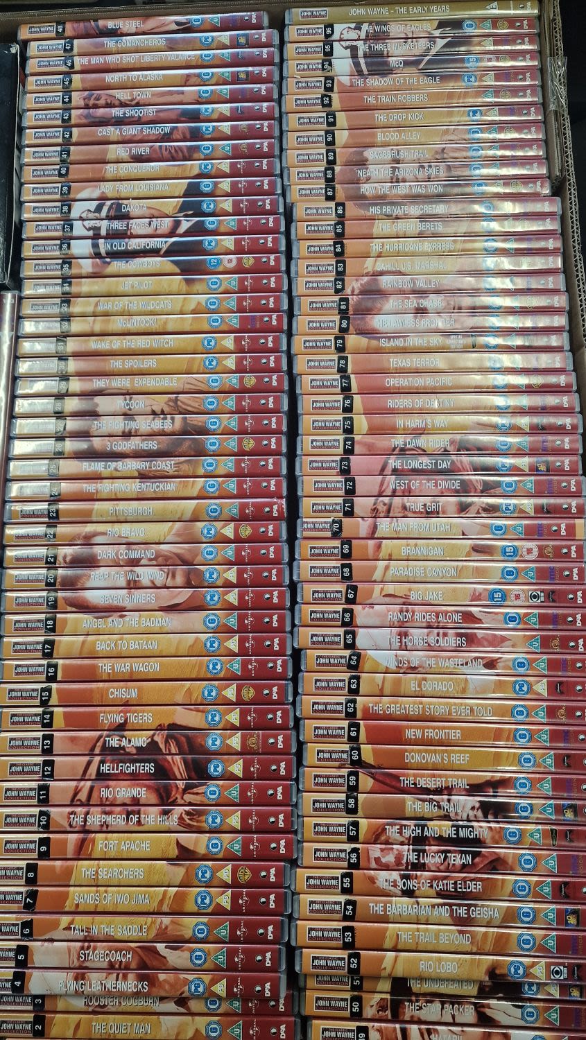Lot 59: A large collection of 99 John Wayne DVDs.