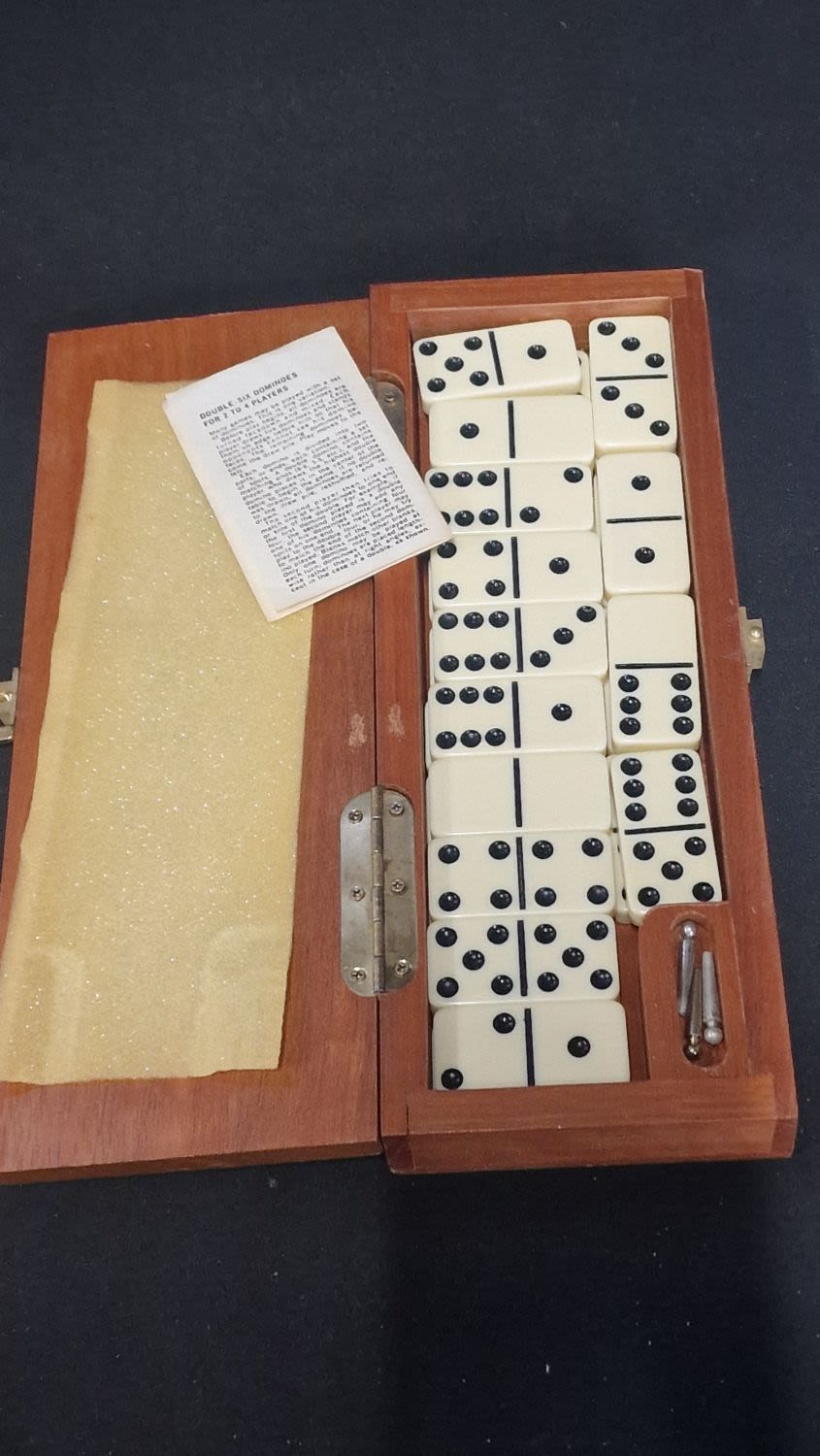 Lot 64: A vintage boxed set of double sixes dominoes...