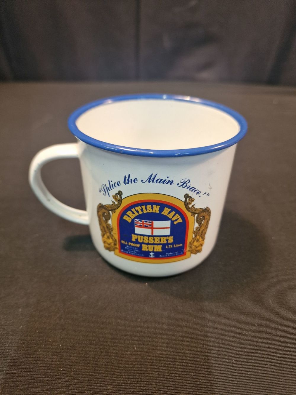 Lot 109: A vintage tin and enamel mug. Bristish Navy....