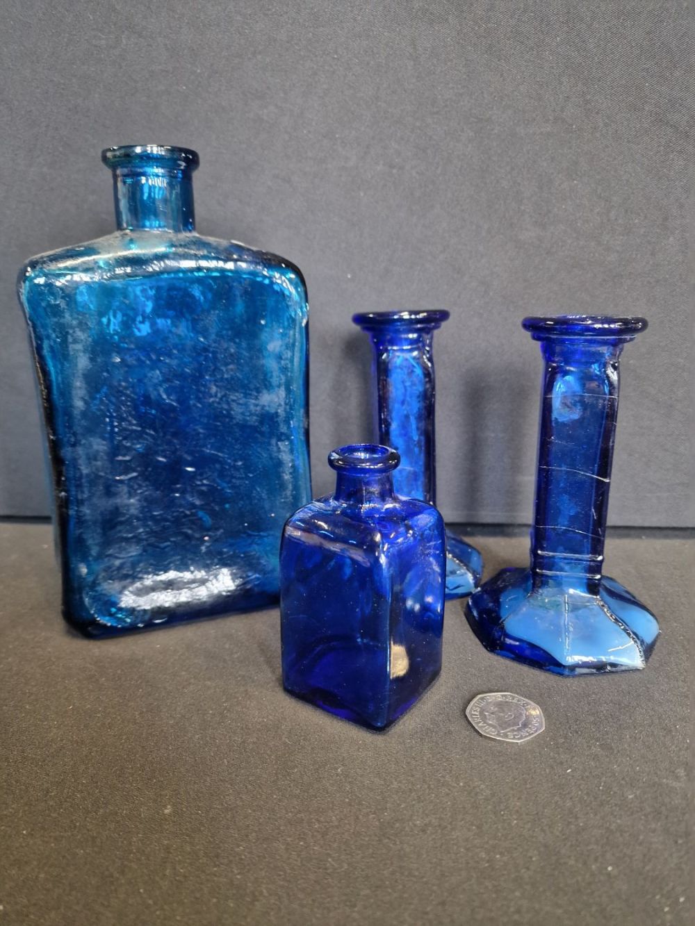 Lot 319: Four pieces of blue glass. Candle sticks and...