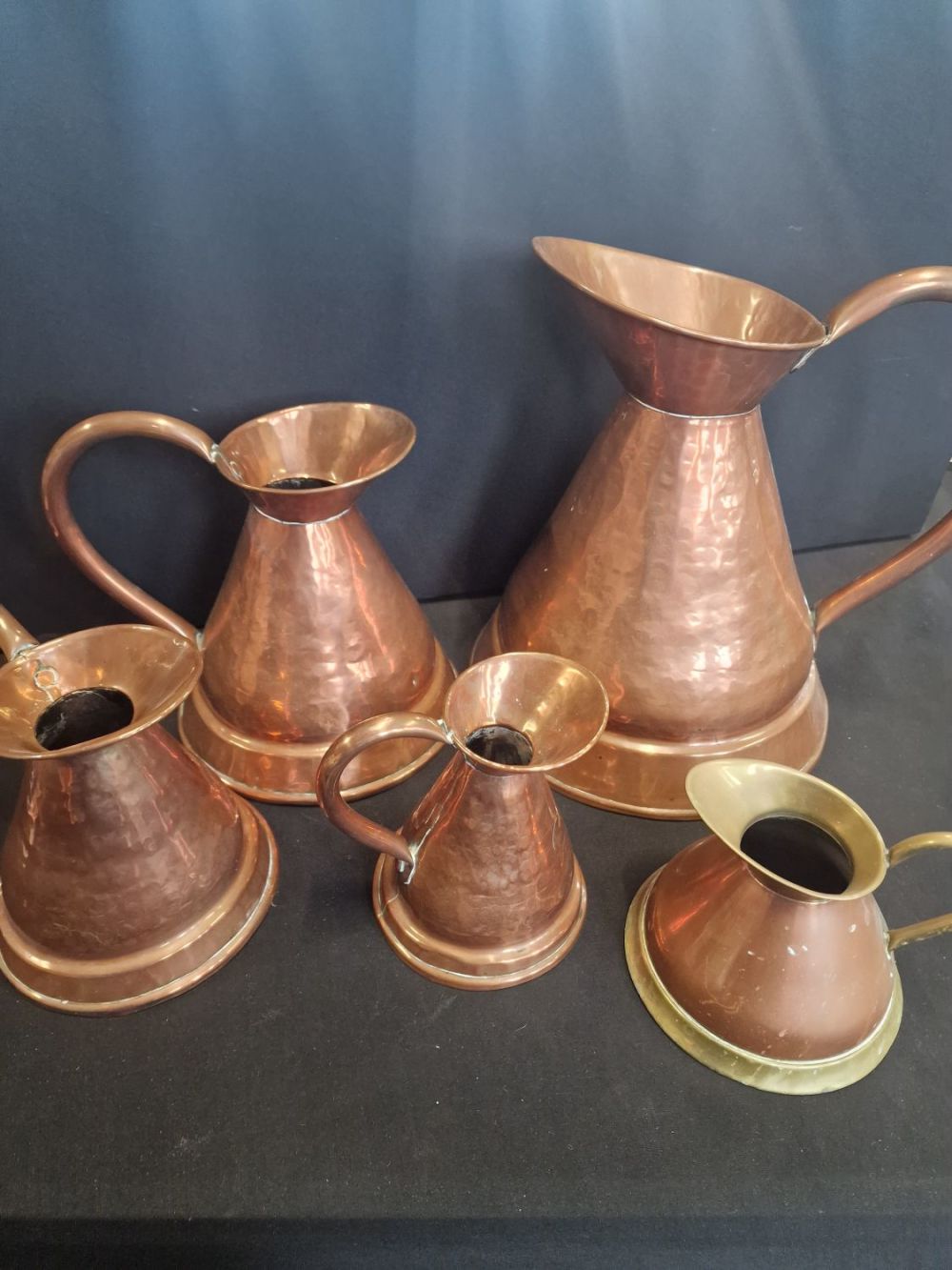 Lot 355: Five copper and brass jugs various sizes