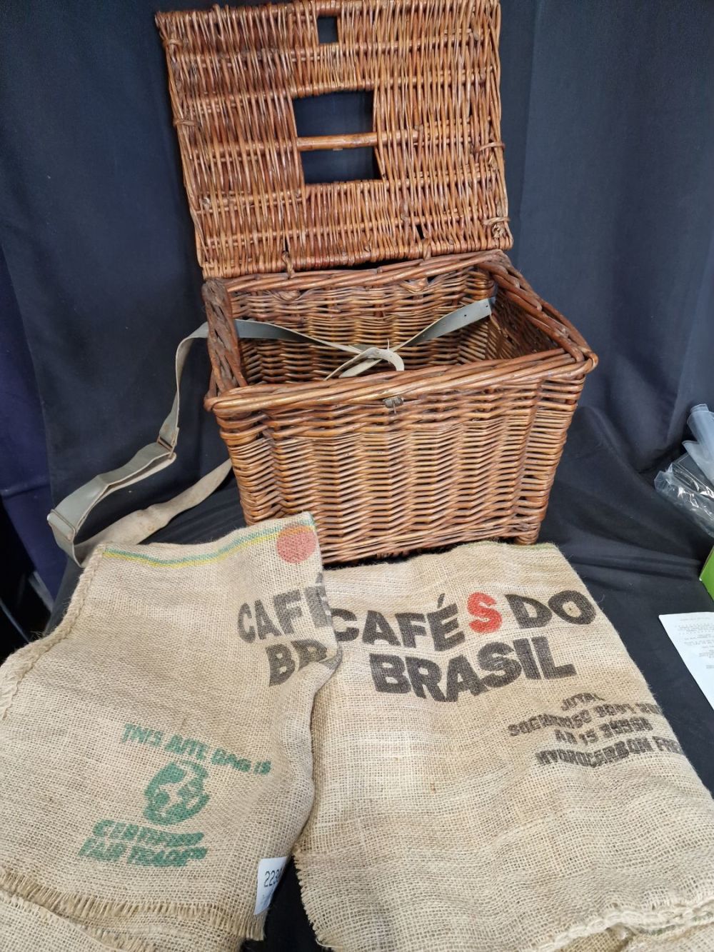 Lot 412: A vintage fishing basket with two hessian sacks