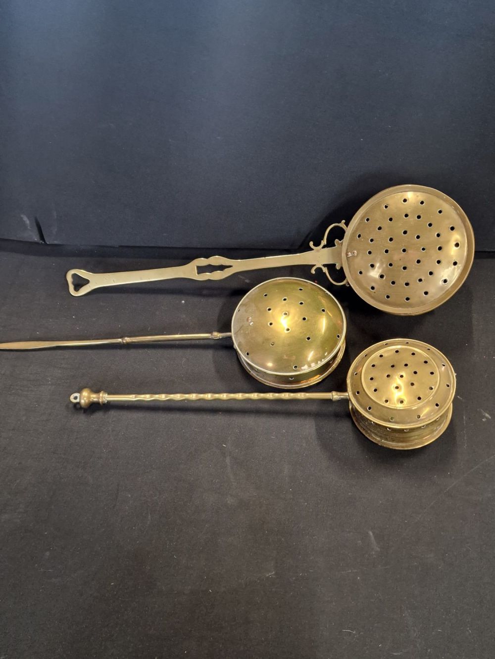 Lot 183: Three various sized vintage brass Chestnut Roasters