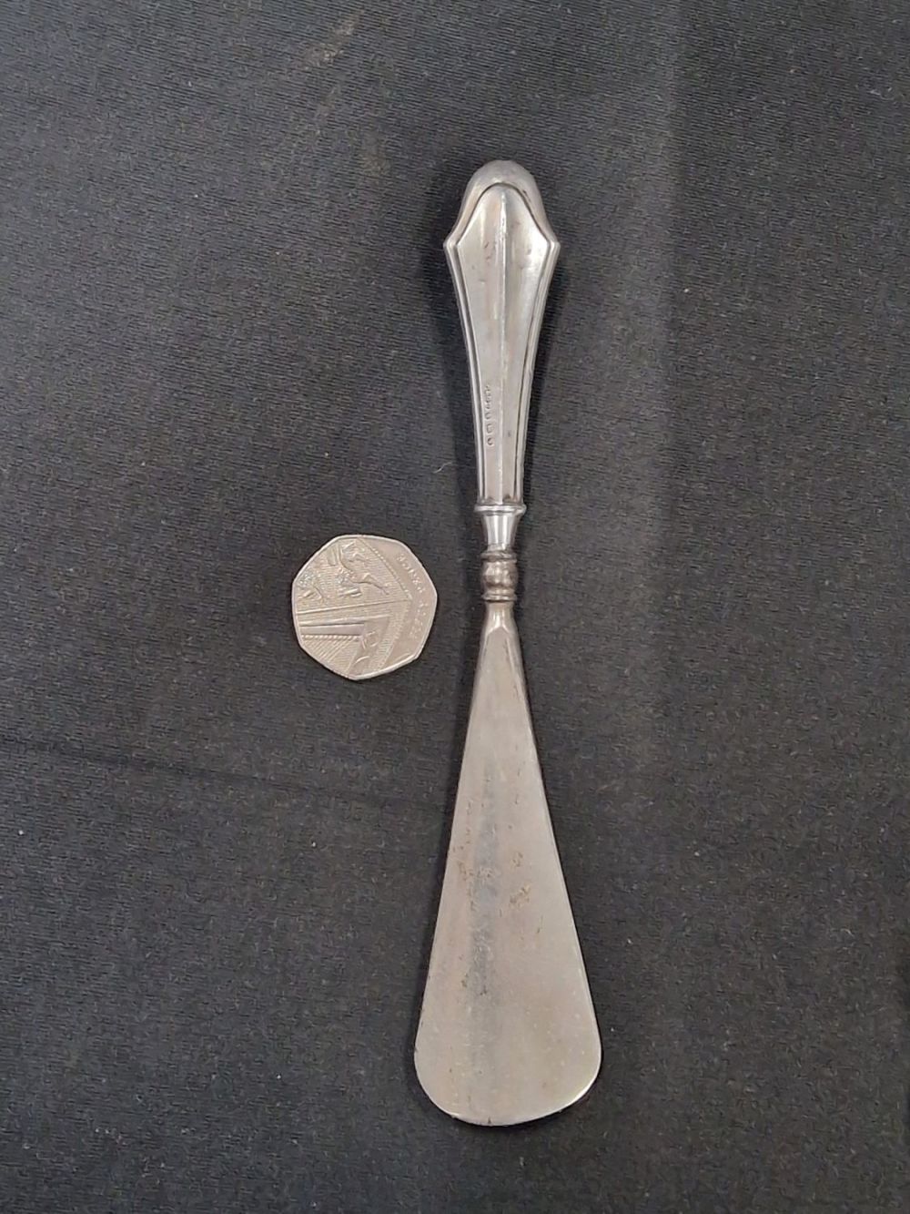 Lot 218: A solid sterling silver handled shoe horn. With...