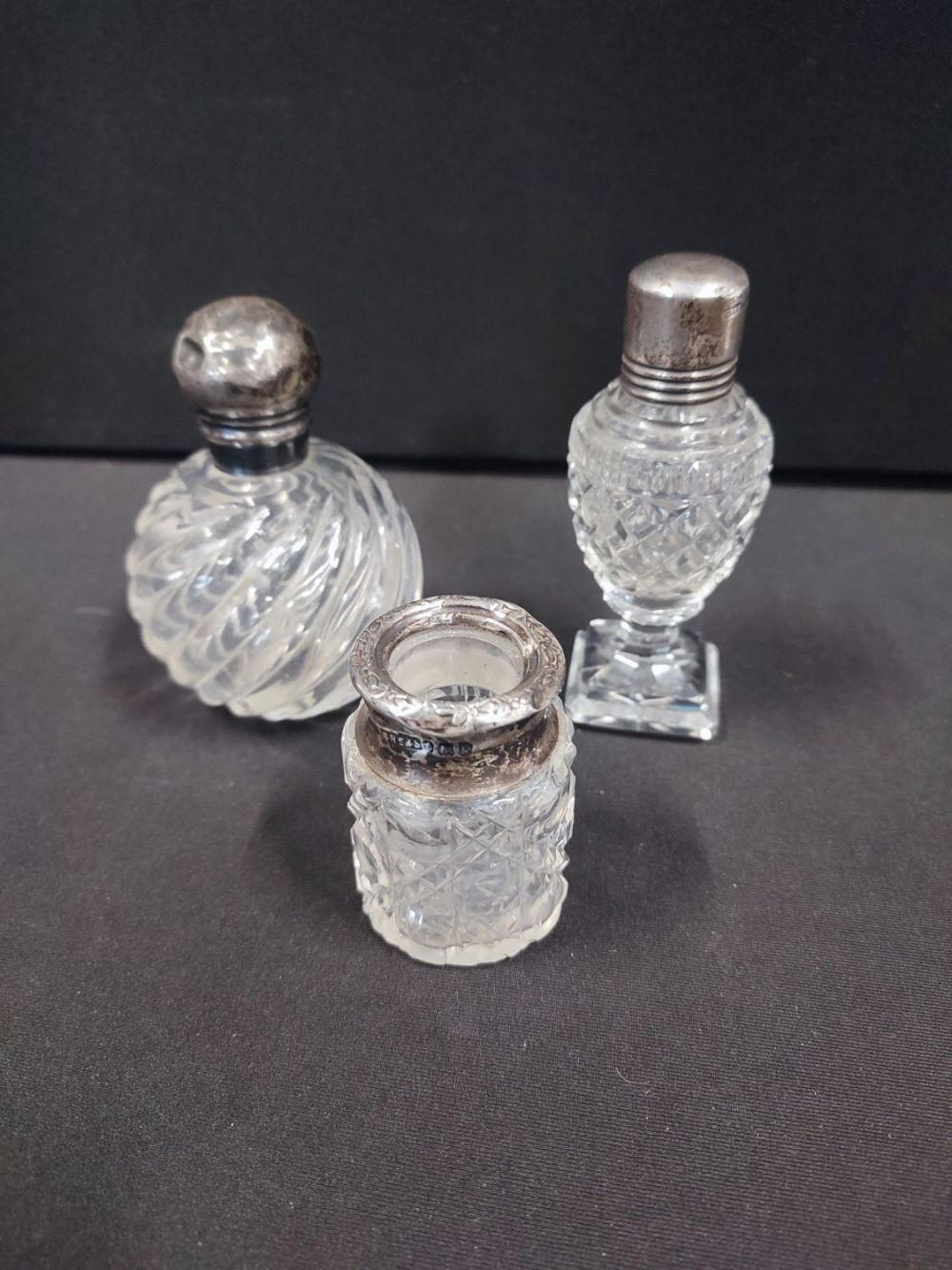 Lot 321: 3 cut crystal scent bottles with Silver lids