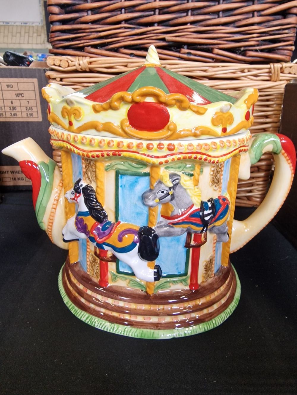 Lot 384: A carousel themed tea pot.