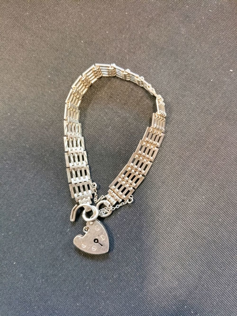 Lot 420: A vintage 1978 sterling silver gate bracelet with...