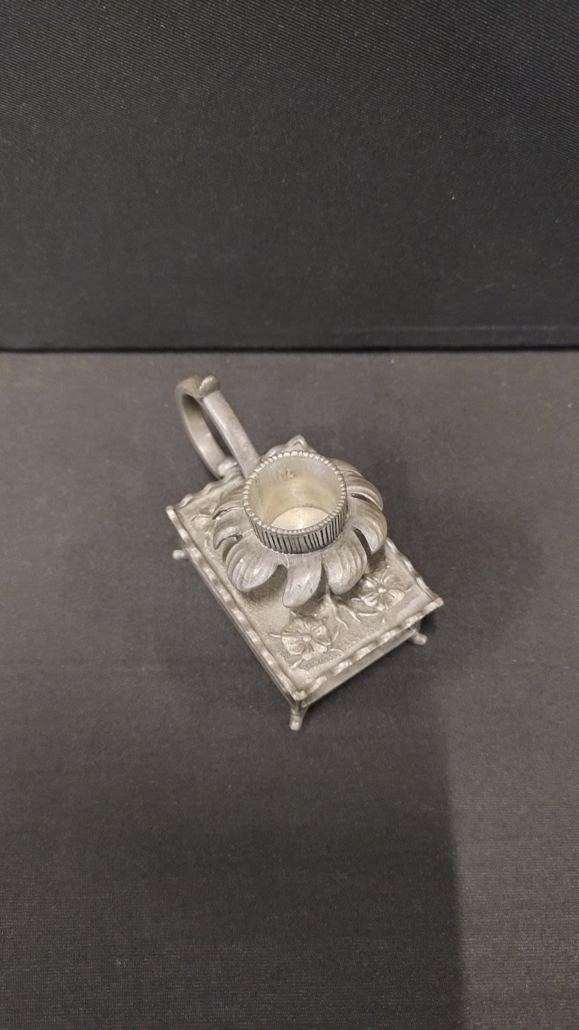 Lot 197: Small white metal candle holder with floral design