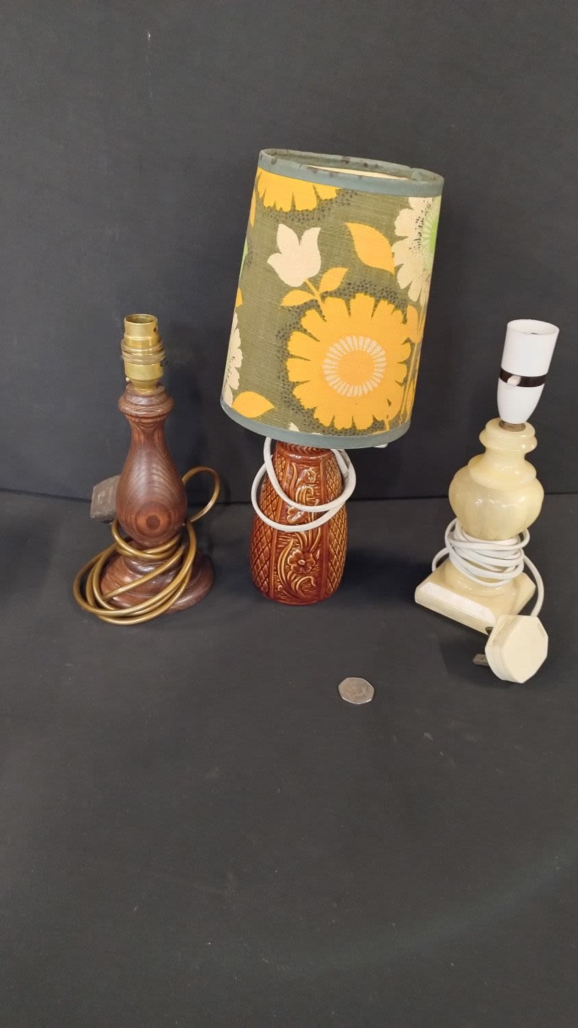 Lot 207: Three small table lamps one wooden with bronze...