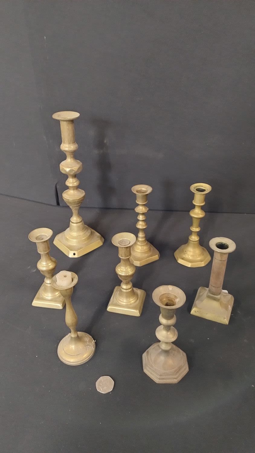 Lot 208: Ten Various brass candle holders, one pair of...