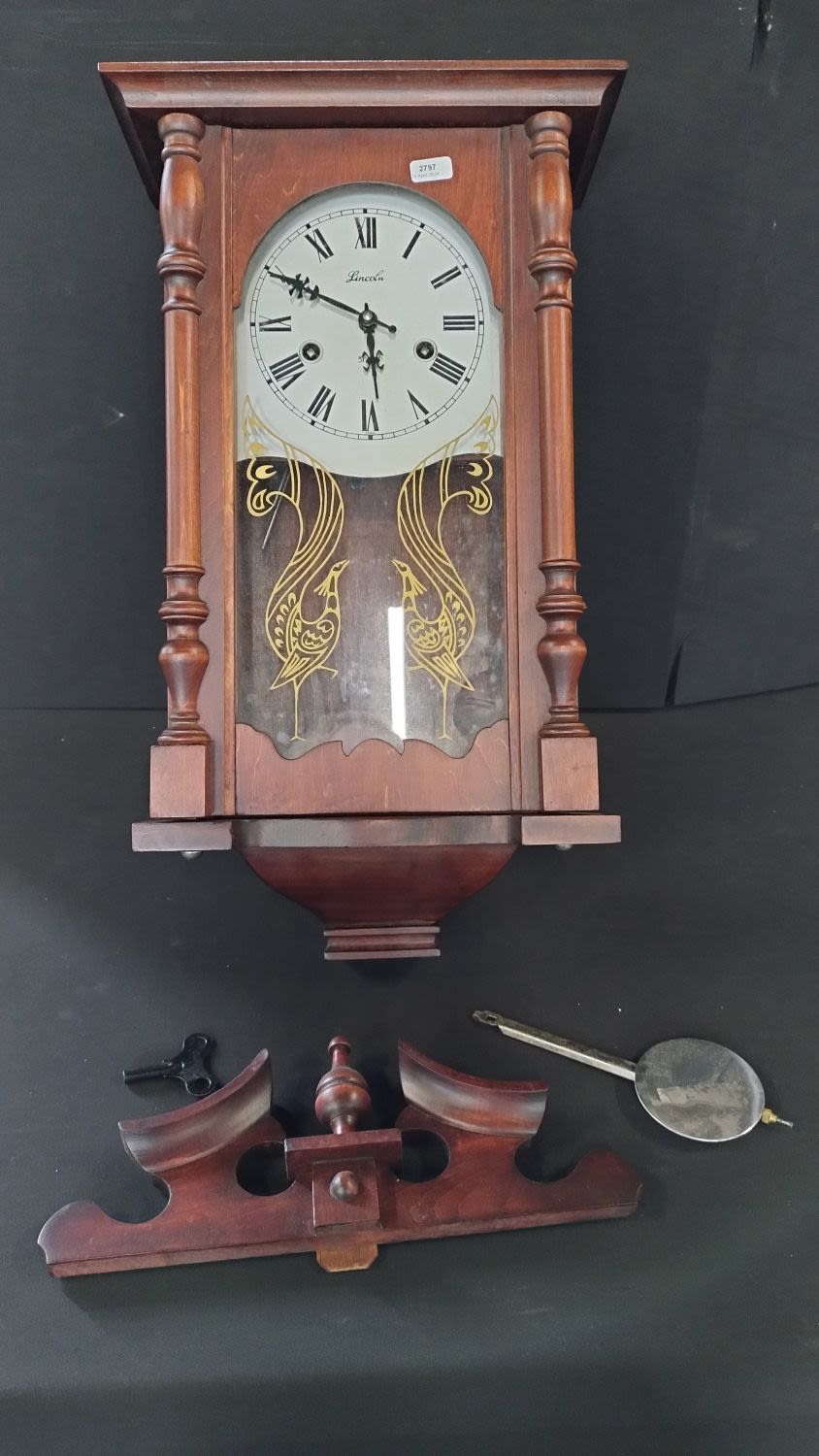 Lot 209: Lincoln 31 day wall hanging clock with key,...
