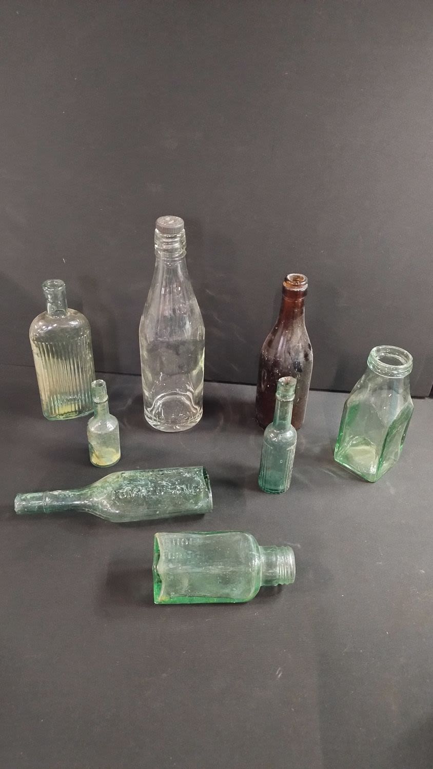 Lot 284: Collection of eight vintage bottles, clear and brown,...