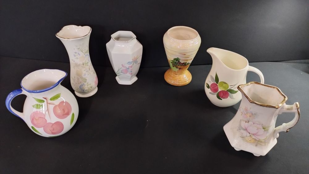 Lot 321: Six vases and jugs, one jug is a...