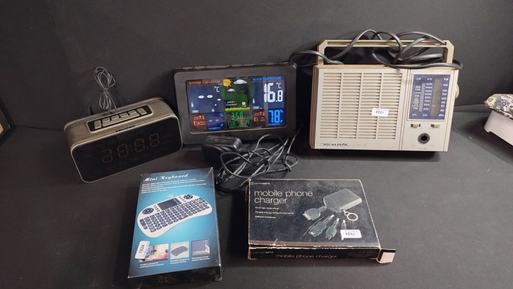 Lot 324: Various items including digital weather station, alarm clock...