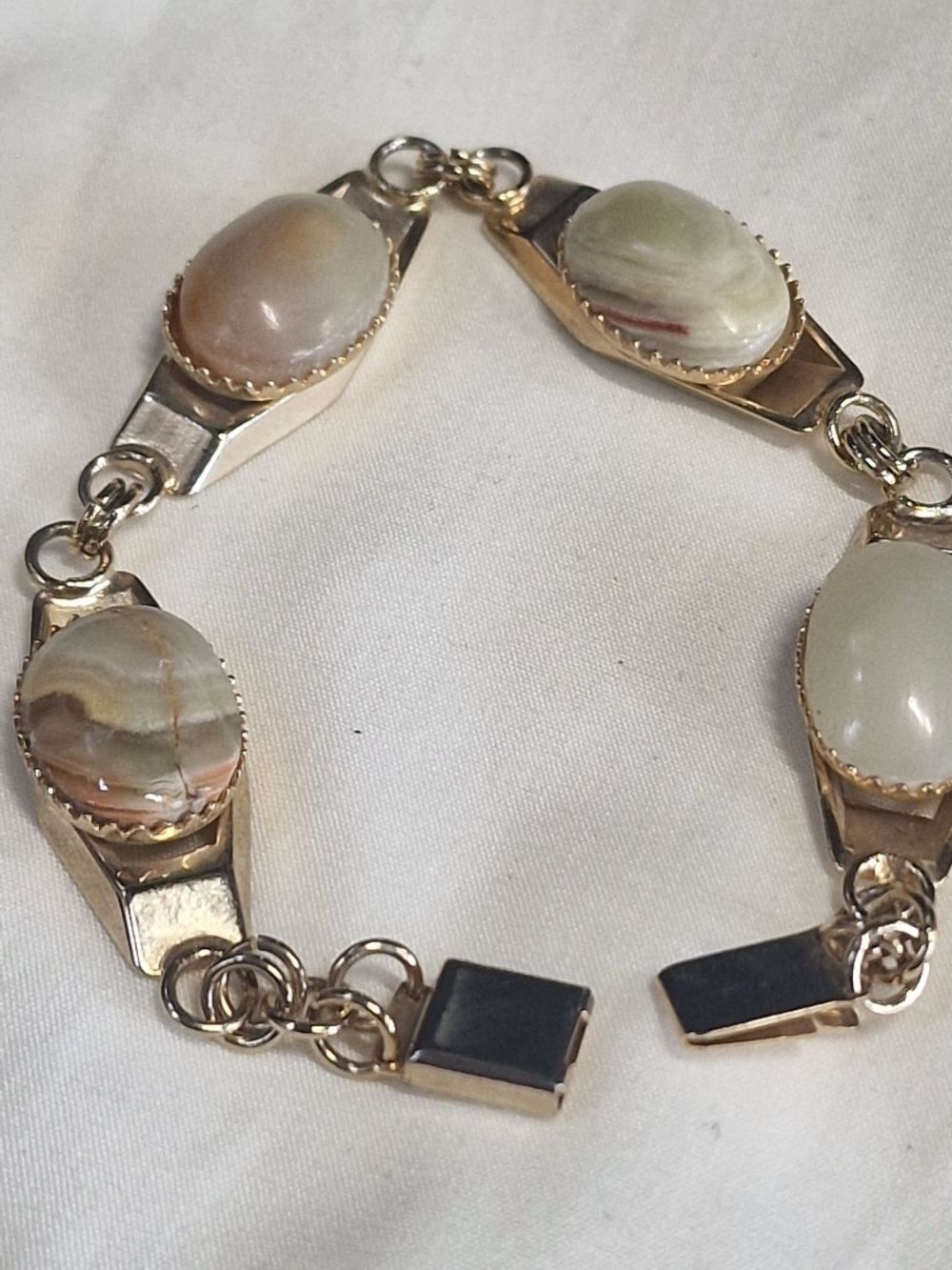 Lot 348: Four Agate stones set in a base metal...