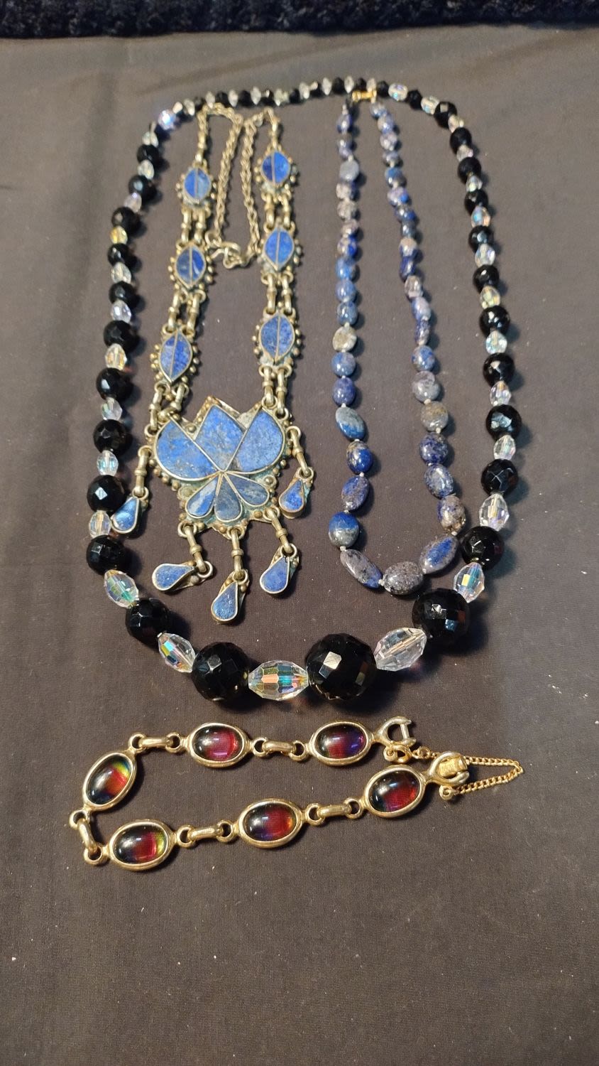 Lot 351: Three necklaces including vintage irridessent and black, lapis...
