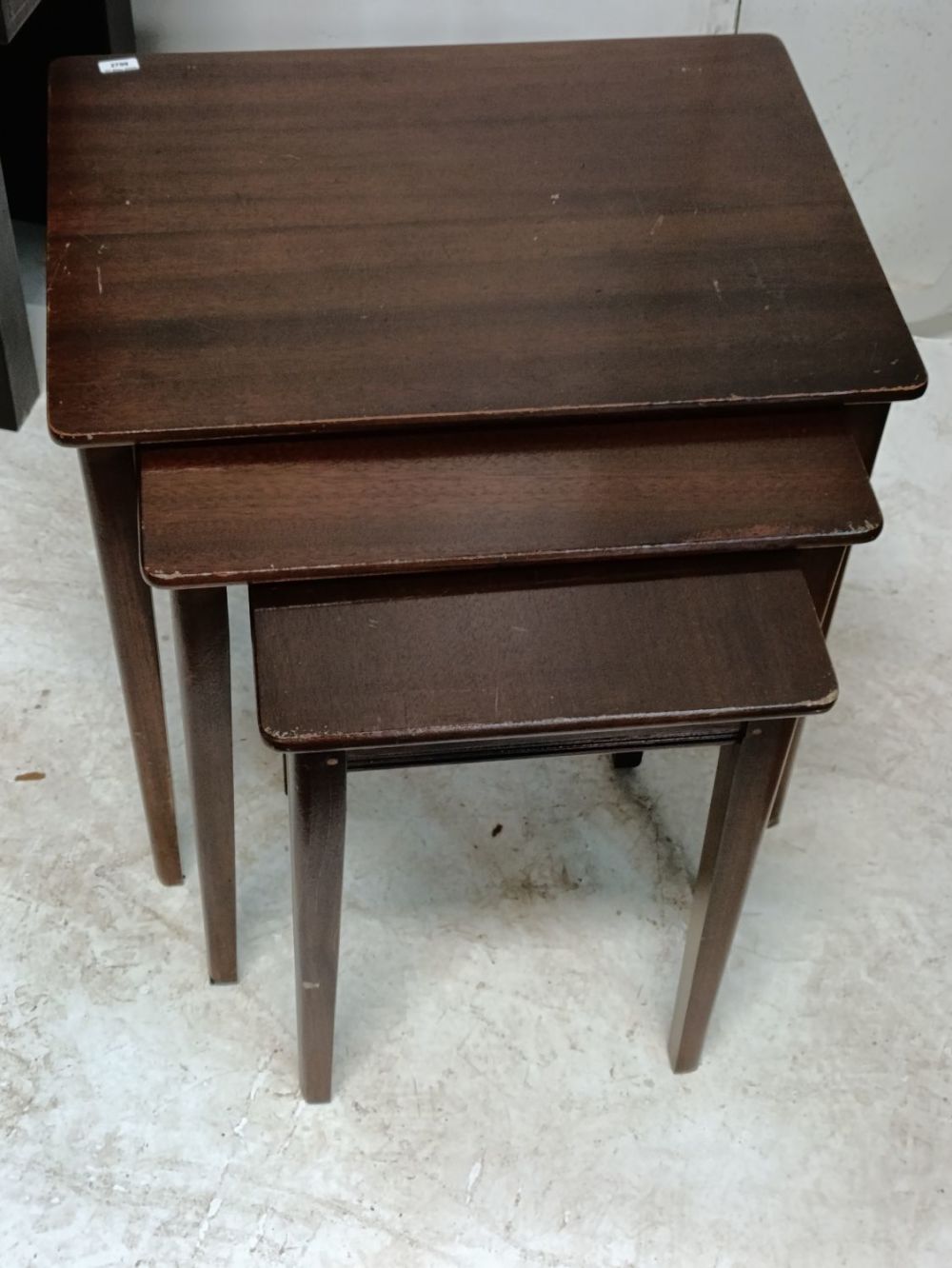 Lot 363: Vintage nest of dark wood tables.
