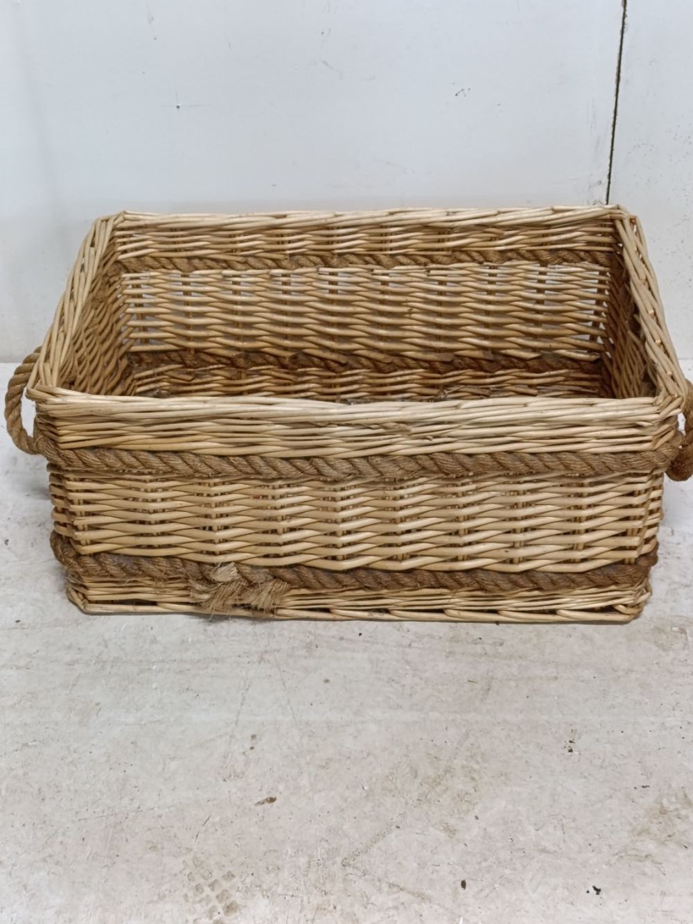 Lot 388: Large wicker basket with rope handles and detailing