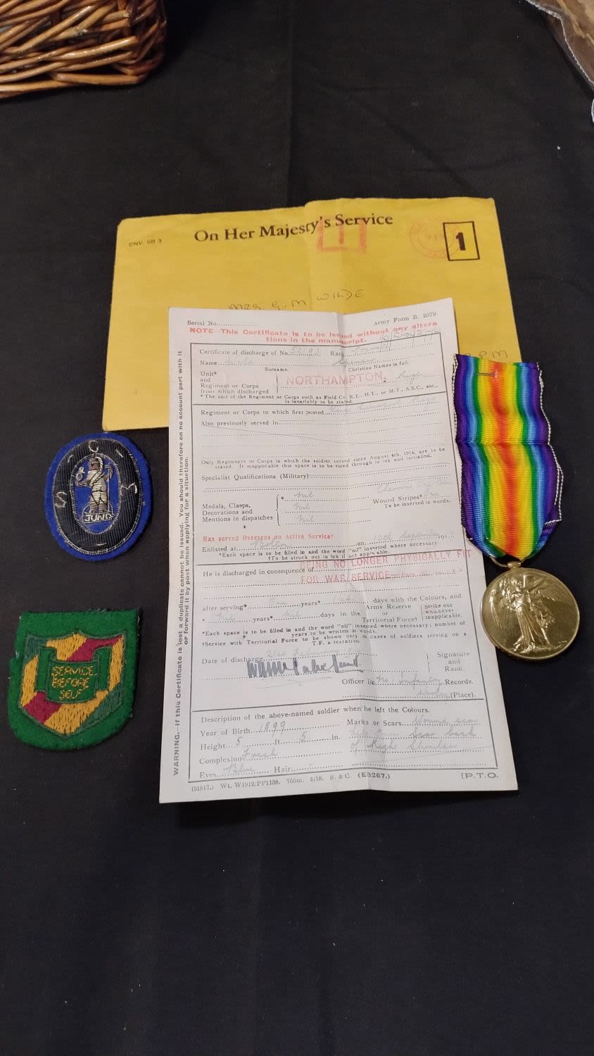 Lot 423: Discharge paper dated 1919, with medal for the...