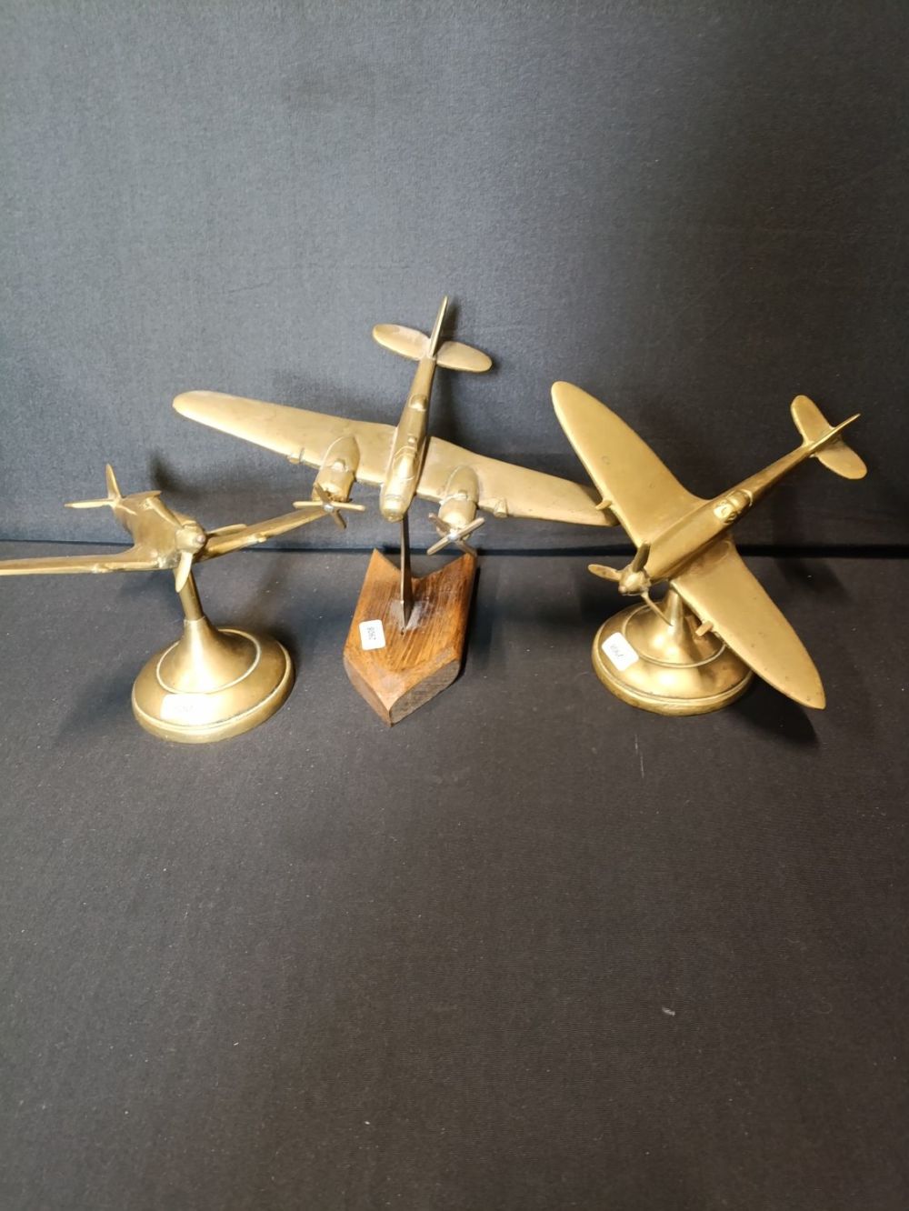Lot 448: 3 vintage brass aeroplane models. 2 spitfires on...