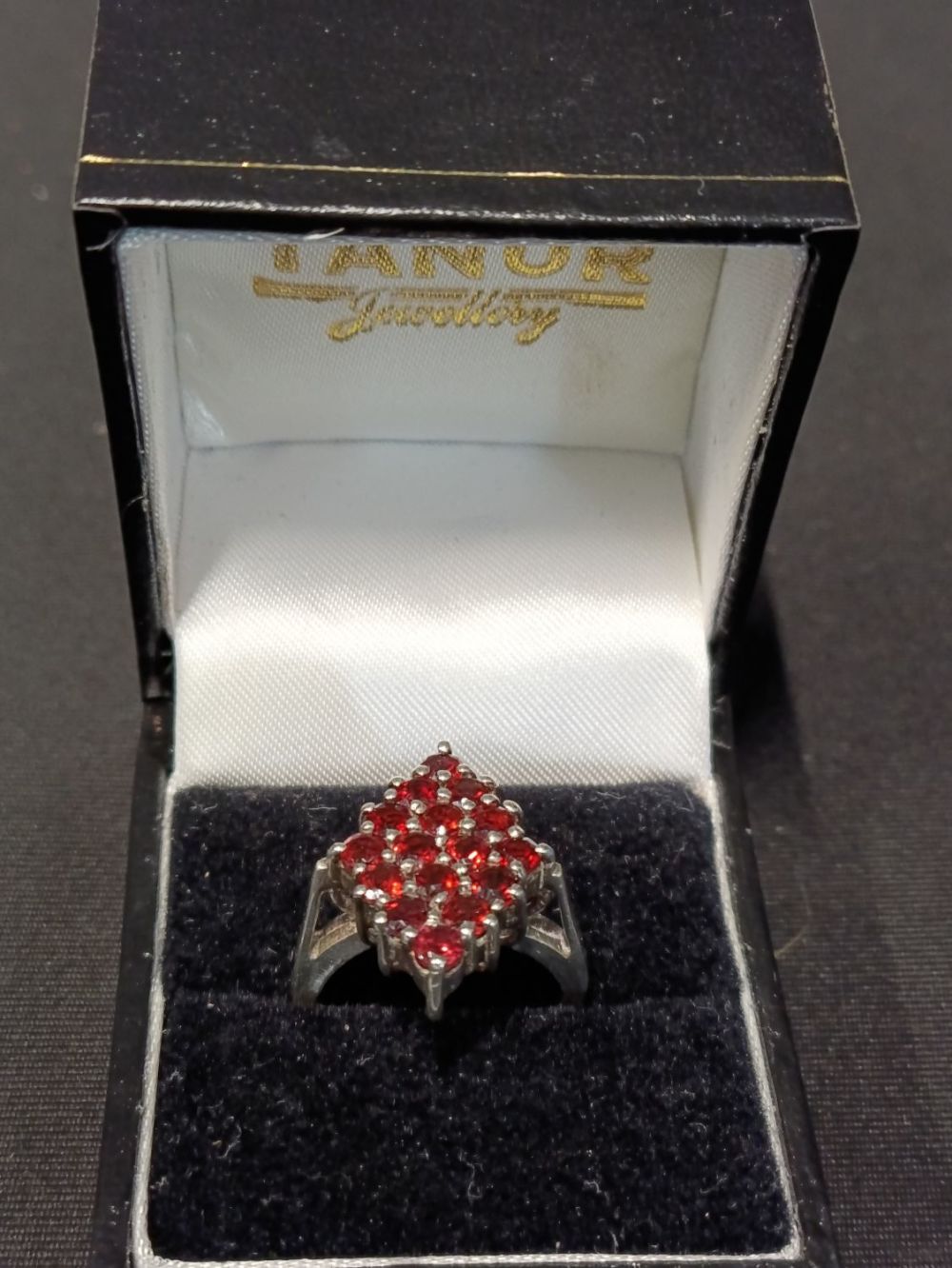 Lot 470: Sterling silver ring with red garnet stones set...
