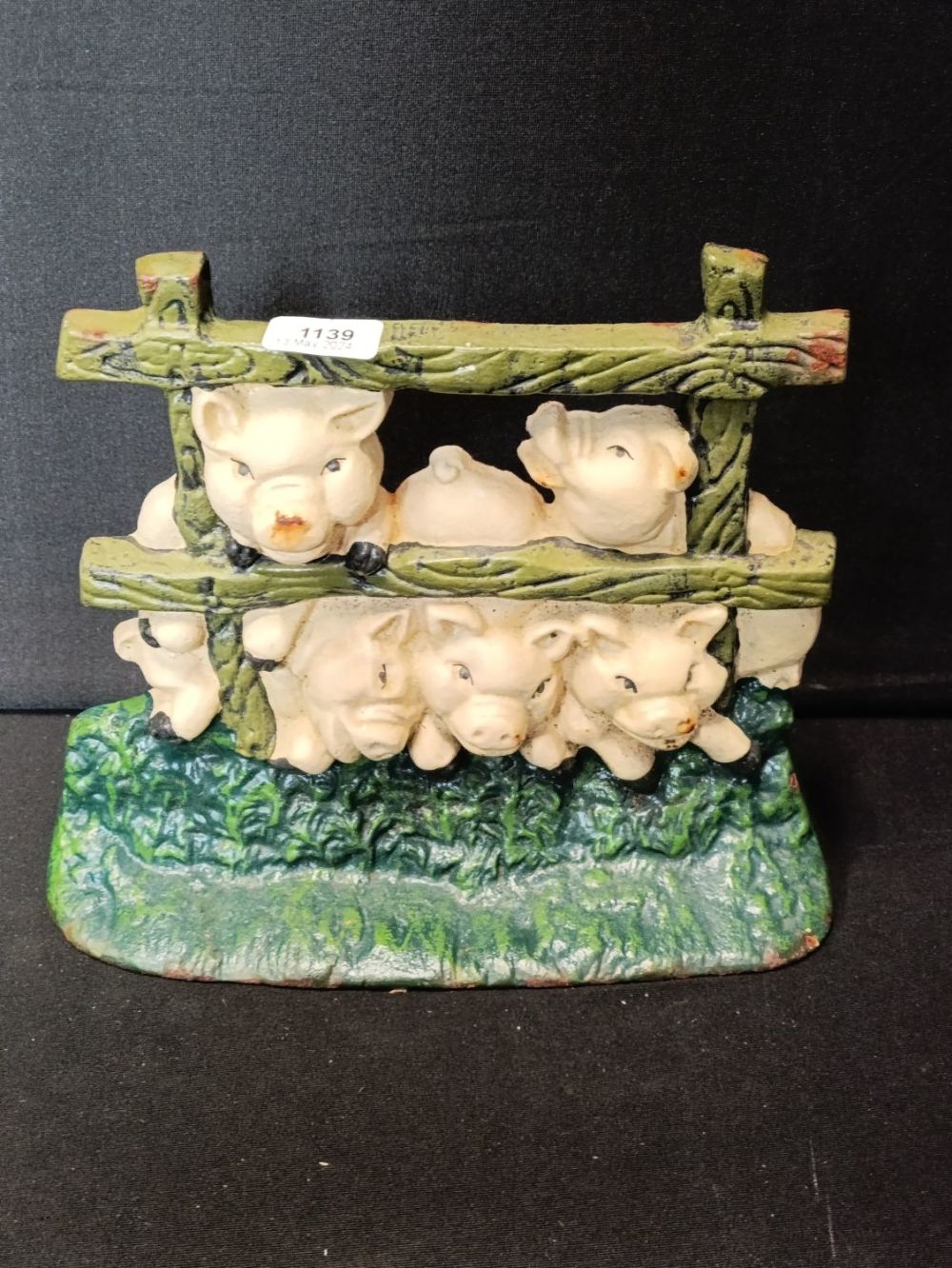 Lot 474: Vintage cast iron pigs in a pen doorstop