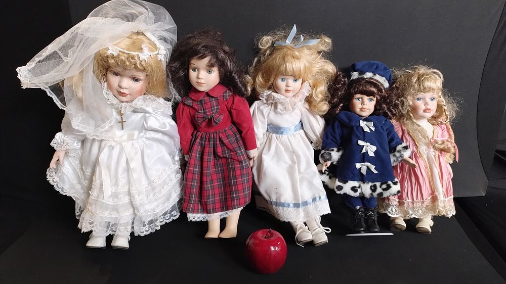 Lot 400: Five porcelain dolls one in a christening dress,...