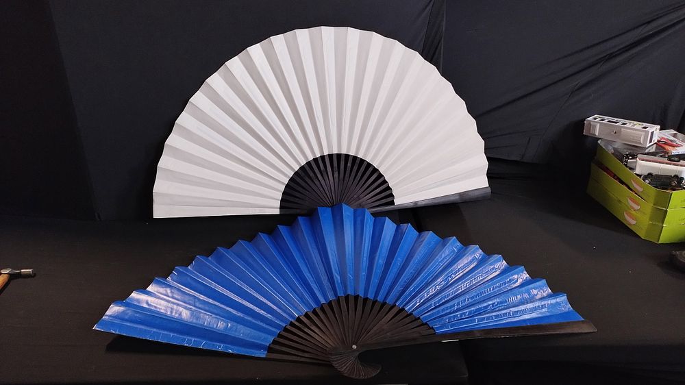 Lot 413: Two plain big display fans, one white one...