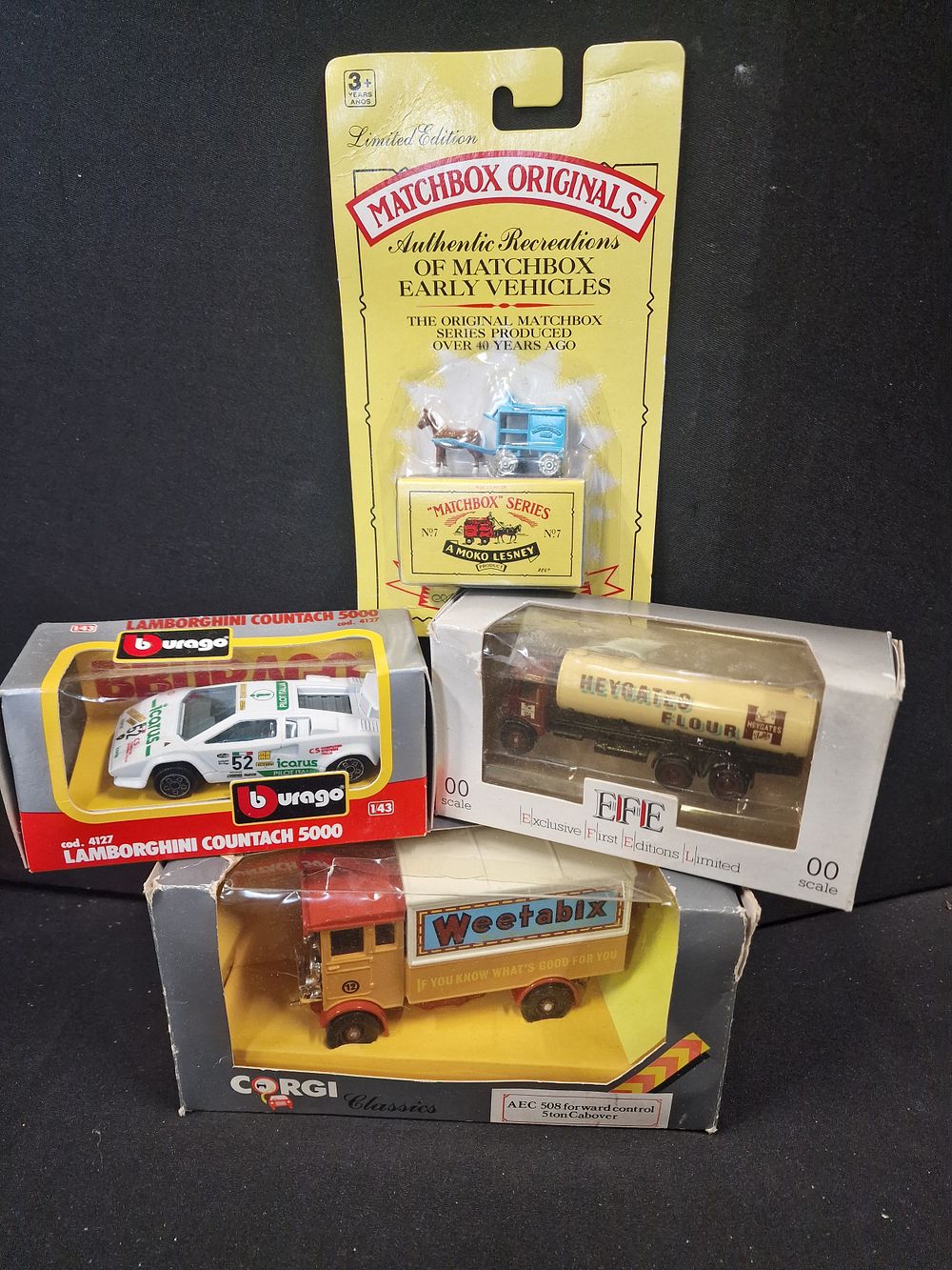 Lot 155: Four Burago, Matchbox, and Corgi die cast models....