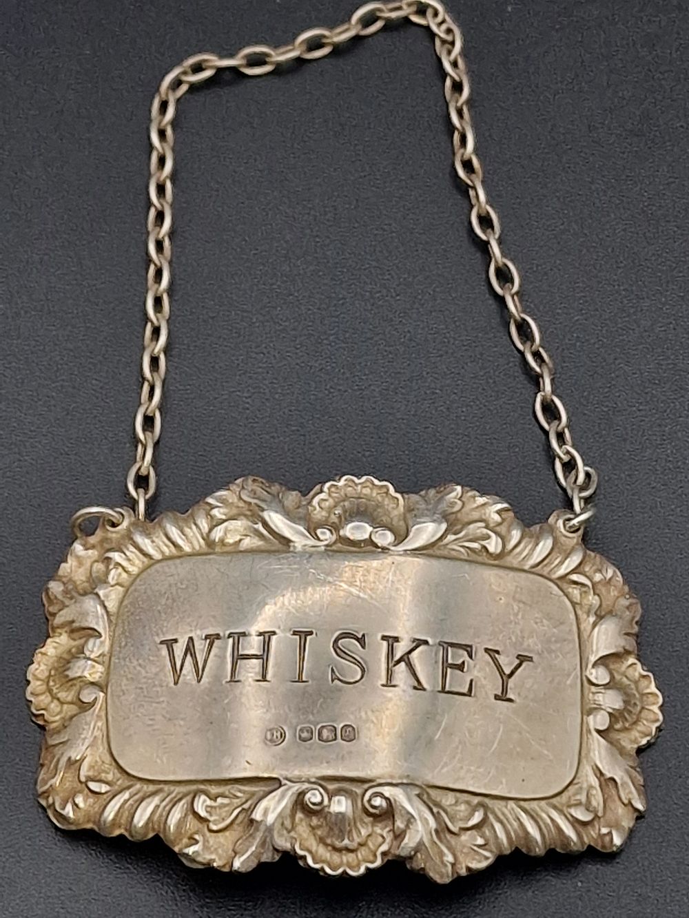Lot 490: A hallmarked WHISKEY decanter tag or label.