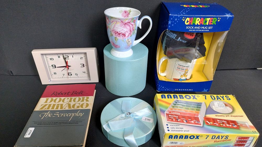 Lot 174: Box of items including character socks and cup...