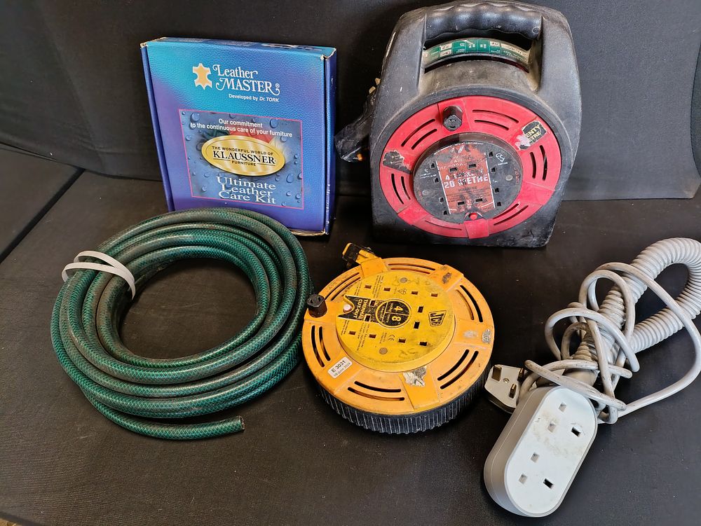 Lot 299: Selection of power extension leads, a hosepipe and...