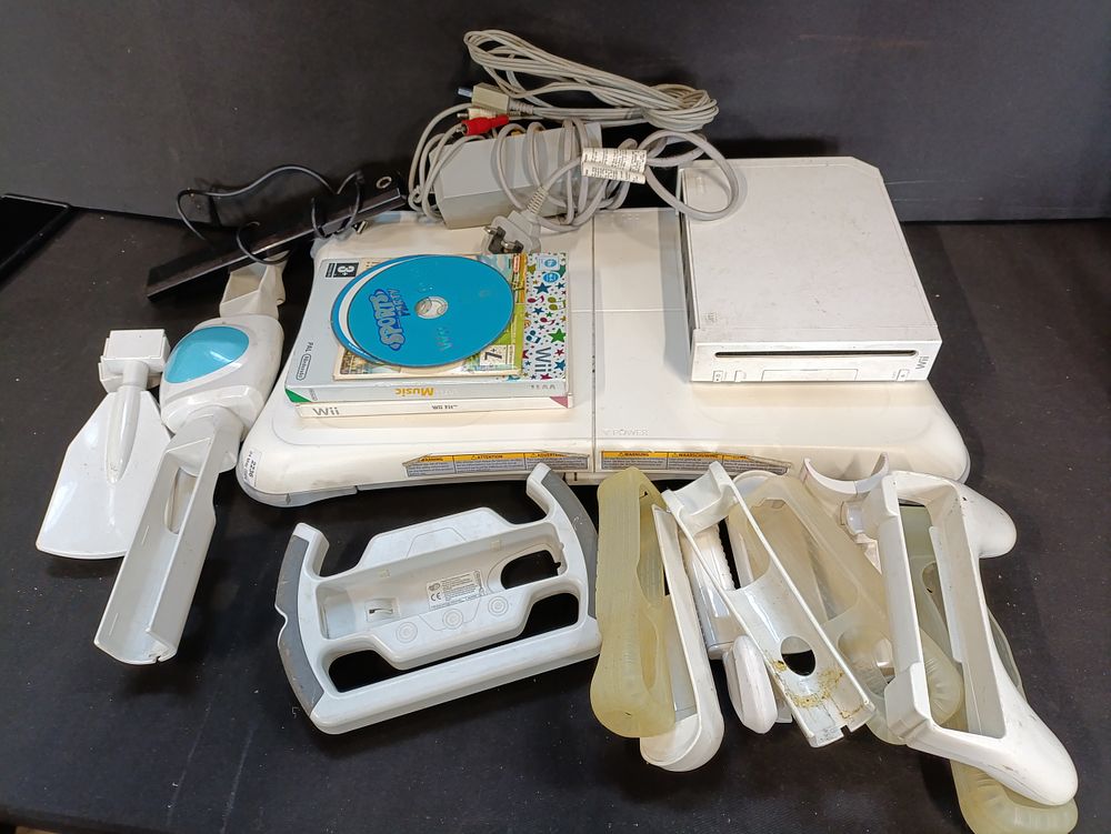 Lot 78: Nintendo Wii console with wires, Wii fit board,...