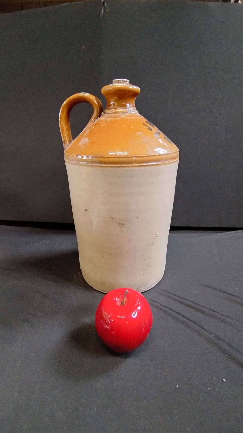 Lot 264: Stoneware flagon with stopper and loop handle J....