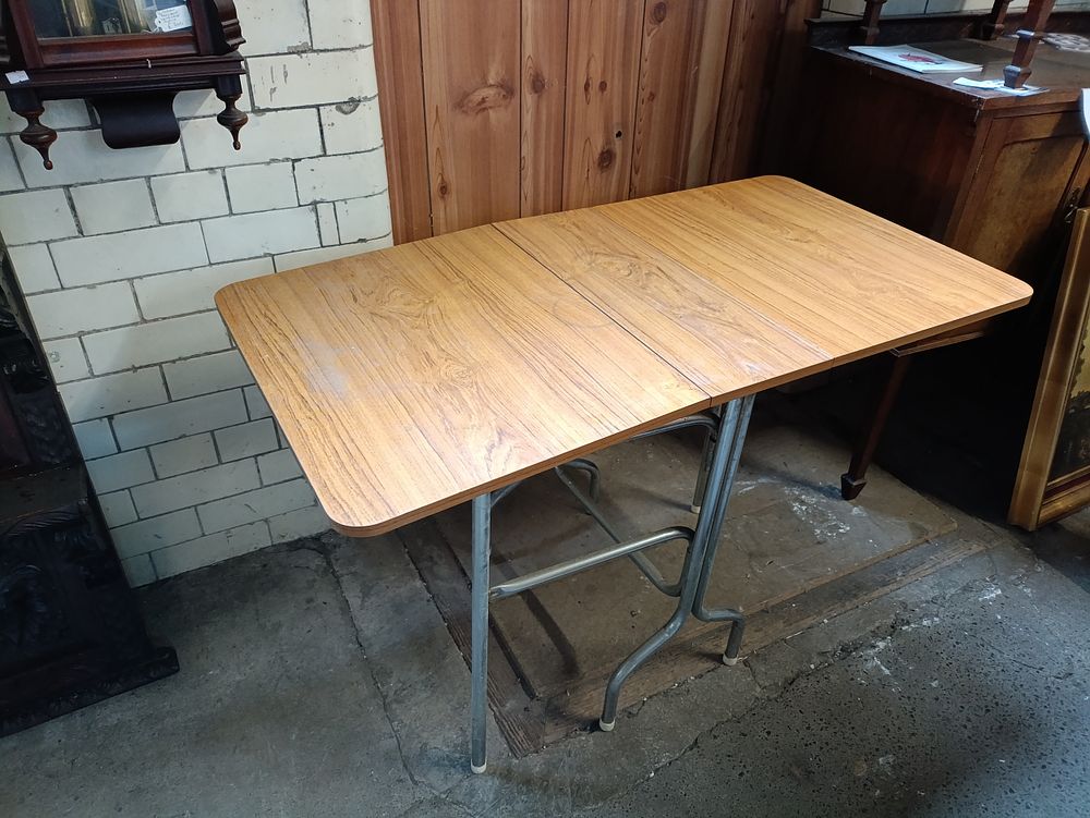 Lot 379: Vintage wooden drop leaf table on metal legs