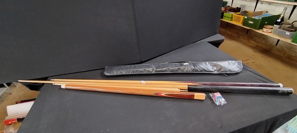 Lot 468: 3 pool cues one is in 2 parts...