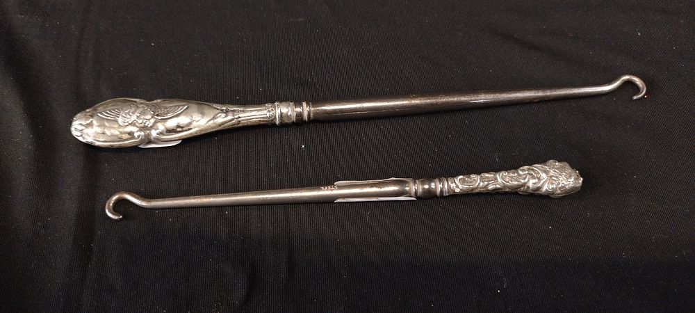 Lot 474: 2 sterling silver button hooks dated 1902 &...