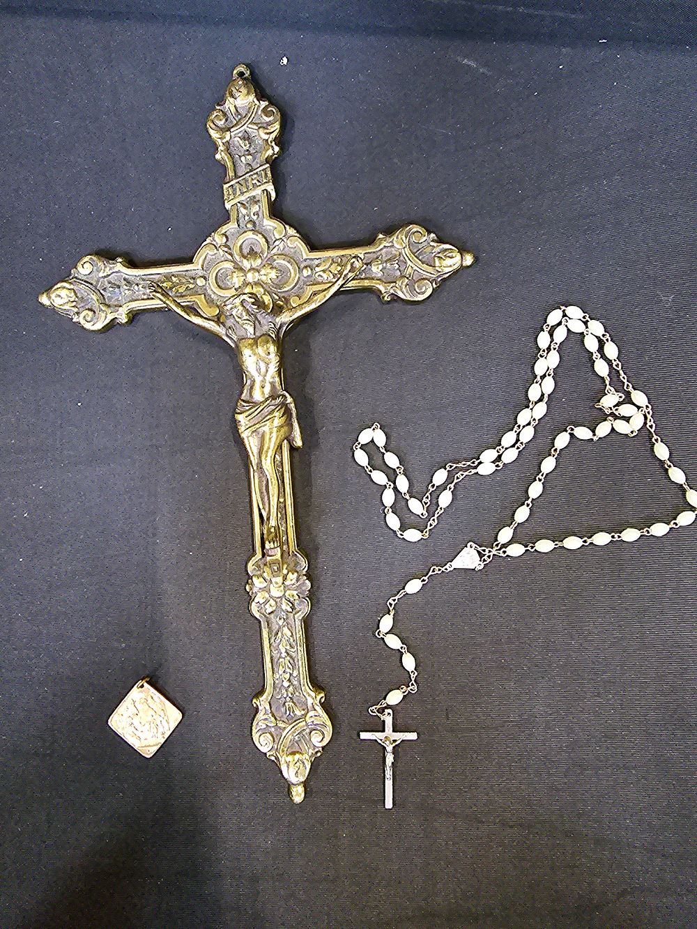 Lot 66: A brass crucifix with religious pendant and rosary...