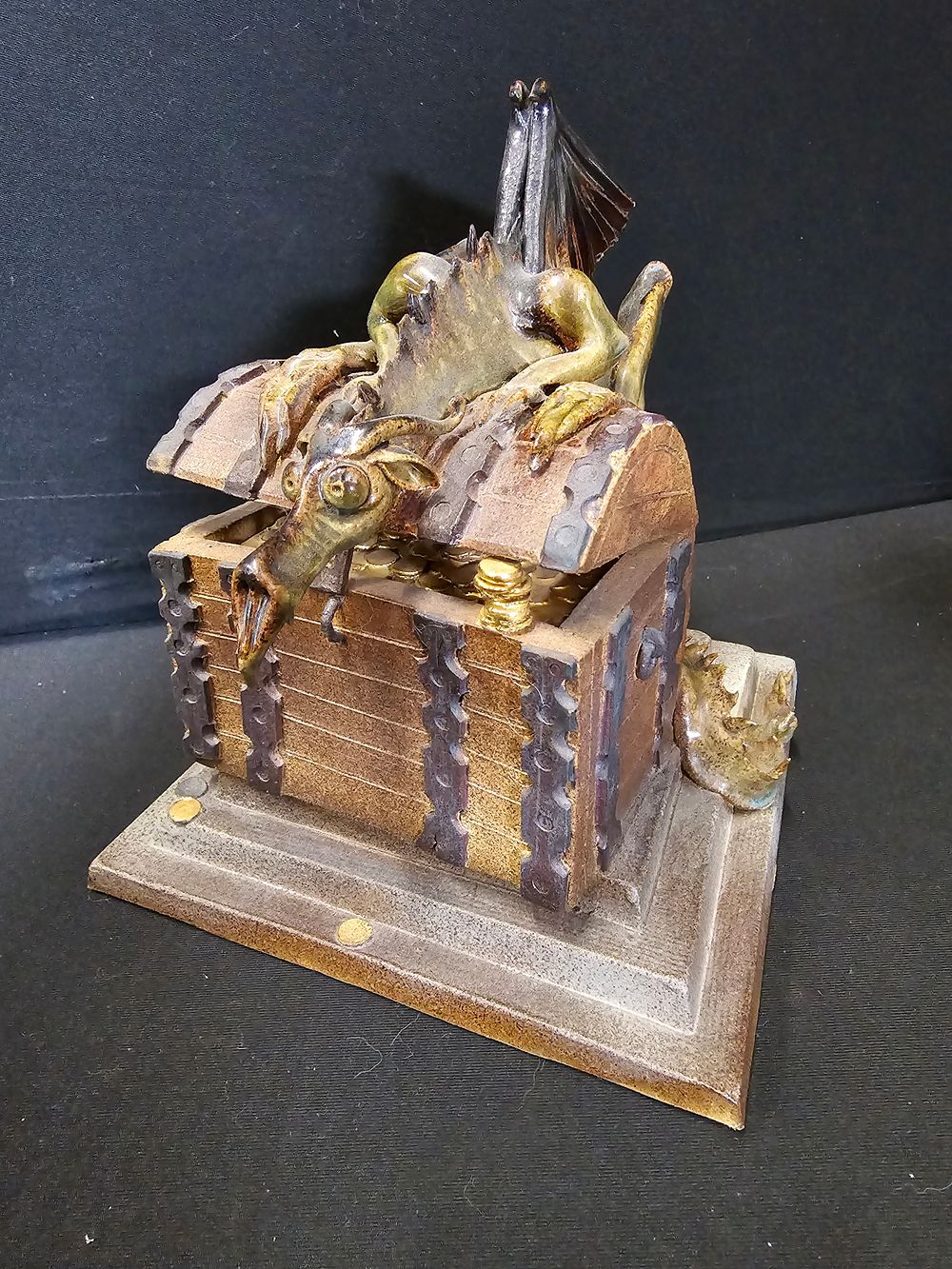 Lot 376: Ceramic Winged dragon protecting a treasure chest.