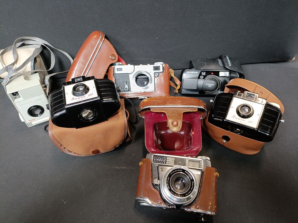 Lot 147: Selection of vintage cameras including Kodak, Olympus and...