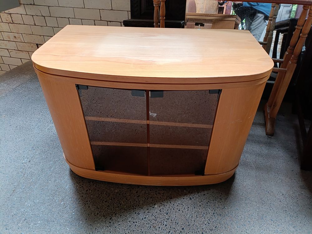 Lot 202: Glass fronted TV cabinet on wheels with swivel...