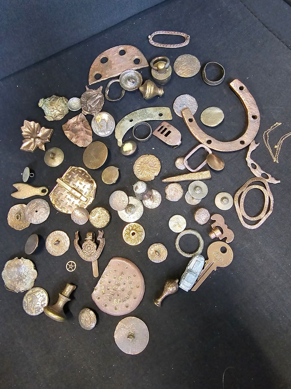 Lot 214: A large collection of buttons, pins, and other...