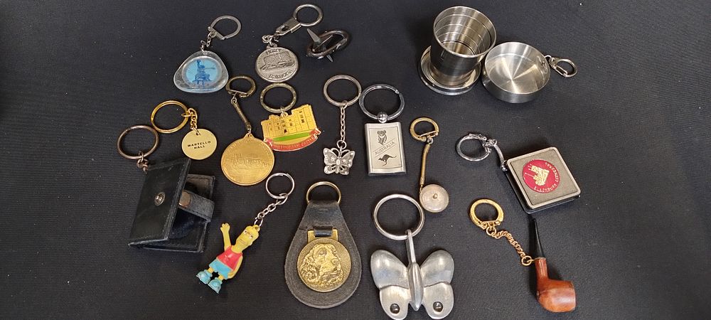 Lot 328: Selection of keyrings including pop up shot glass,...