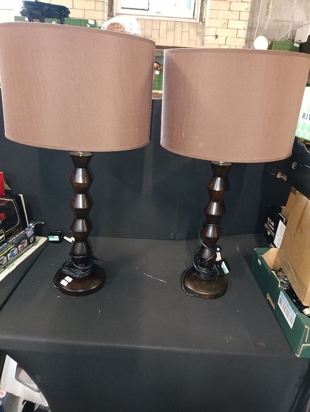 Lot 319: Pair of wooden table lamps in dark wood...