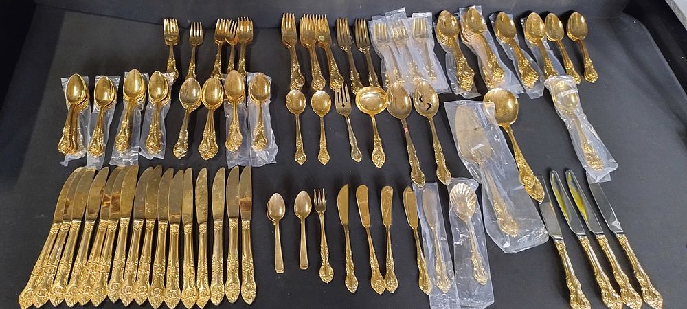 Lot 192: 157 x piece Gold plated coloured cutlery set.
