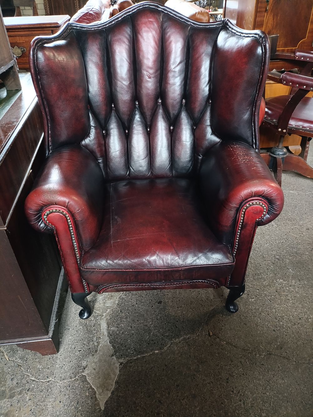 Lot 257: Oxblood Chesterfield wingback armchair
