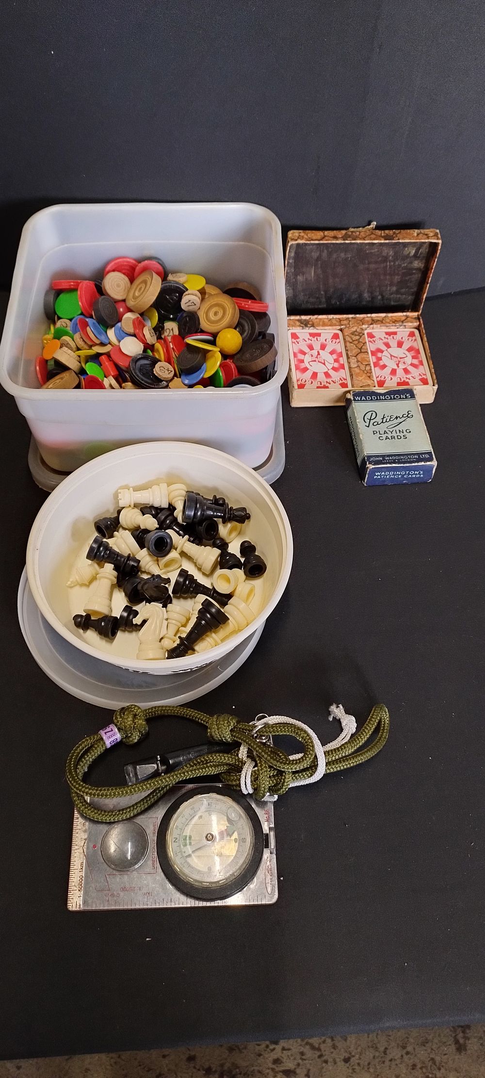 Lot 125: Vintage game pieces, playing cards and a compass